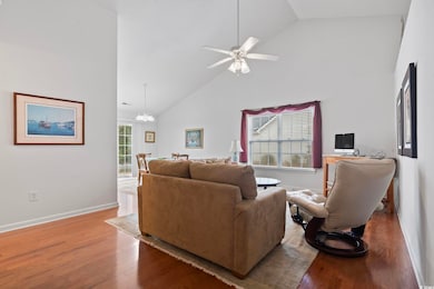 Living room with high vaulted ceiling, ceiling fan