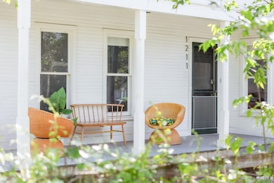 View of exterior entry featuring covered porch