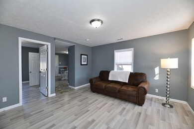 Living Room open to Kitchen and Den.