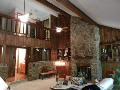 Stone & Soaring Ceilings w/glass walls across back