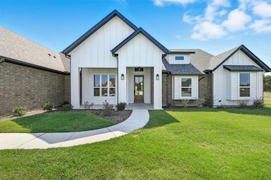 Modern farmhouse featuring roof with shingles, board and batten siding, and a front lawn