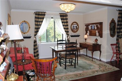 Large dining room with hardwood floors is spacious