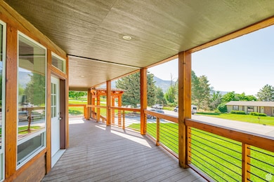 Deck with a mountain view and a lawn