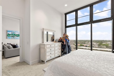 Bedroom with a wall of windows, baseboards, access