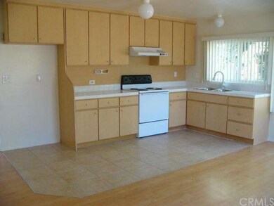 Kitchen with newer countertop, stainless sink, and