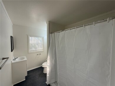 Full bath with vanity, toilet, baseboards, a showe