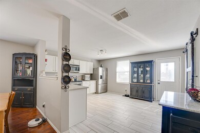 Sliding barn door on right opens to oversized laun