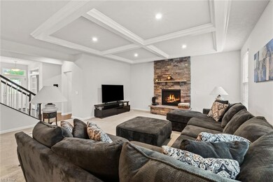 Family room featuring a fireplace, coffered ceilin