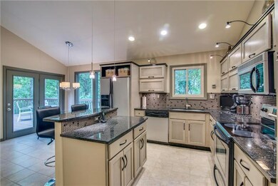Large light filled kitchen with eat-in bar and breakfast area