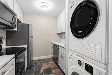 New kitchen with shaker white cabinetry.  Washer/d