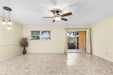 Spare room with light tile patterned floors and ceiling fan