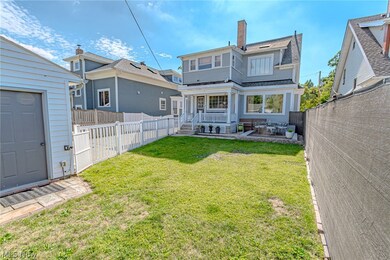 Back of house with a lawn