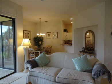 Carpeted living room featuring an inviting chandel