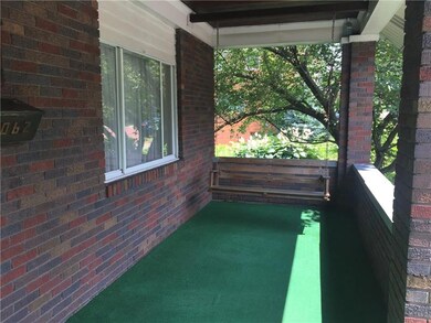 Welcoming front porch, swing is included!