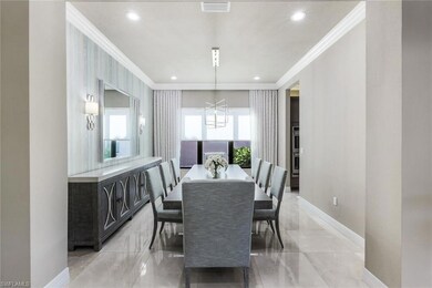 Formal Dining room with crown molding, custom wall paper, designer lighting