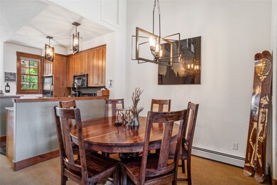 Dining space with a baseboard radiator, a chandeli