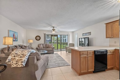 Kitchen with open floor plan, a peninsula, light c