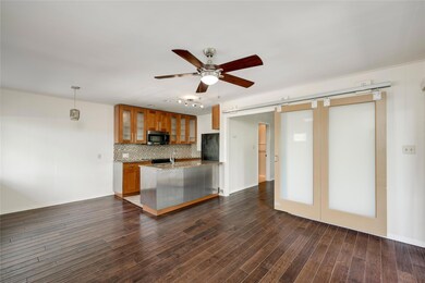 Kitchen featuring a barn door, freestanding refri