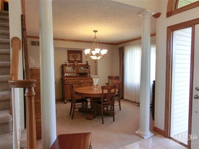 A formal dining room with pillars