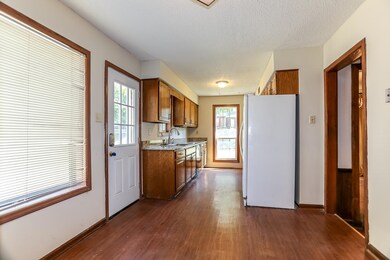 Kitchen with sink, light stone counters, a texture