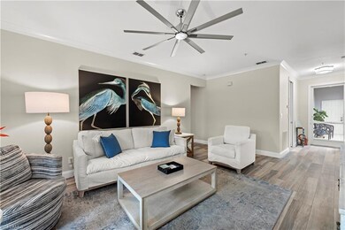 Living room featuring ceiling fan, wood-type floor