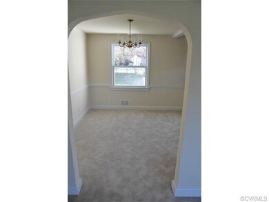 Formal dining room with chandelier and chair raili