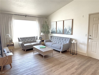 Living room with vaulted ceiling, wood finished fl