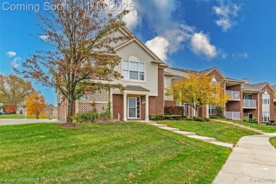 Traditional-style house featuring brick siding and a front yard