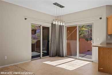 Unfurnished dining area featuring baseboards, tile