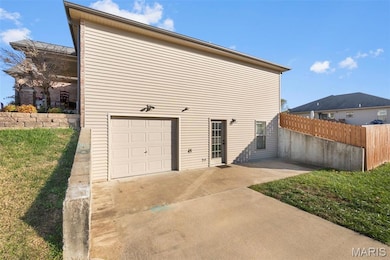 Garage featuring concrete driveway
