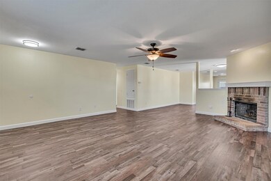Unfurnished living room with ceiling fan, a firepl