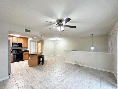 Kitchen with a breakfast bar area, light tile pat