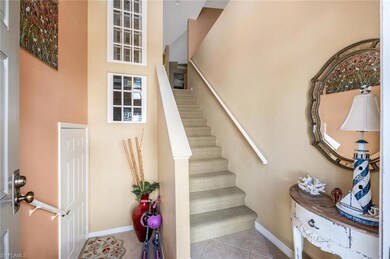 Stairway with tile patterned flooring and baseboar