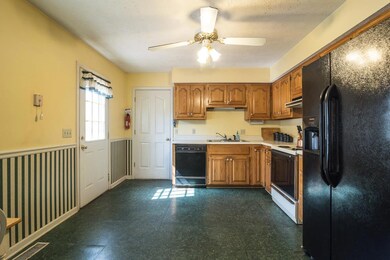 Kitchen with doors to the two car garage and deck