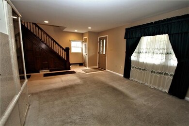 Living room with view of staircase.  (Entertainmen