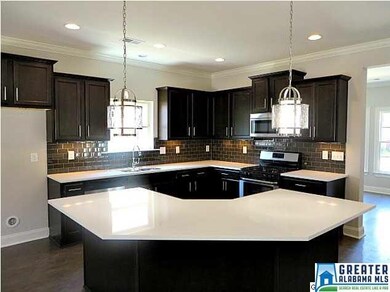 Gourmet Kitchen Features Espresso Cabinets, Quartz