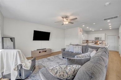 Living area with visible vents, baseboards, ceilin