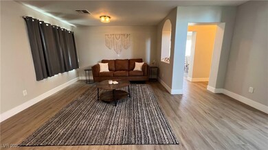 Living area featuring arched walkways, visible ven