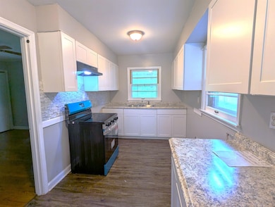 Kitchen featuring range with electric cooktop, und
