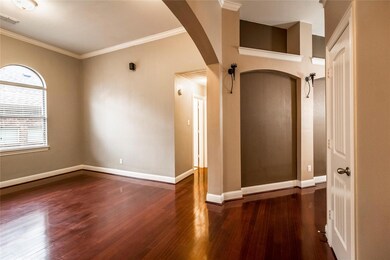 Empty room featuring ornamental molding and dark hardwood / wood-style floors