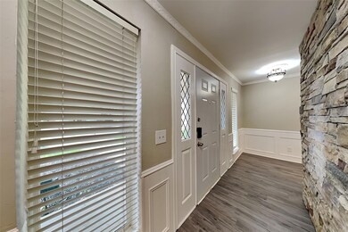 Entryway with crown molding and dark hardwood / wo