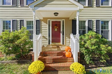 Doorway to property featuring covered porch