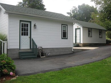 New garage; both have matching siding and asphalt 