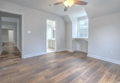 Additional living space featuring ceiling fan and wood-type flooring