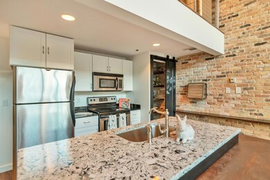 Kitchen features Under mount over-sized sink, Quartz Island, Stainless Steel appliances. 
