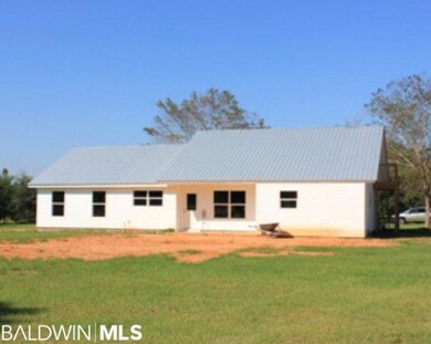 Back view of home. Home sits on a knoll and has wo