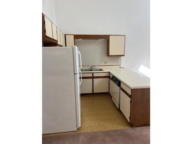 Kitchen featuring light countertops, a sink, frees