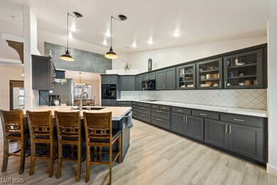 Kitchen with black appliances, a breakfast bar are