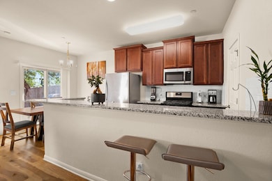 Kitchen featuring a kitchen breakfast bar, light 