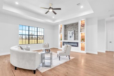 Living area featuring visible vents, a raised ceil